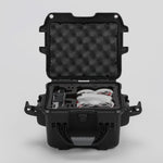 Front view of DJI Neo Black Color Adventure Ready Compact Waterproof Carry-on Case and Custom Foam Insert with a Red Layer, holding the DJI Neo Combo