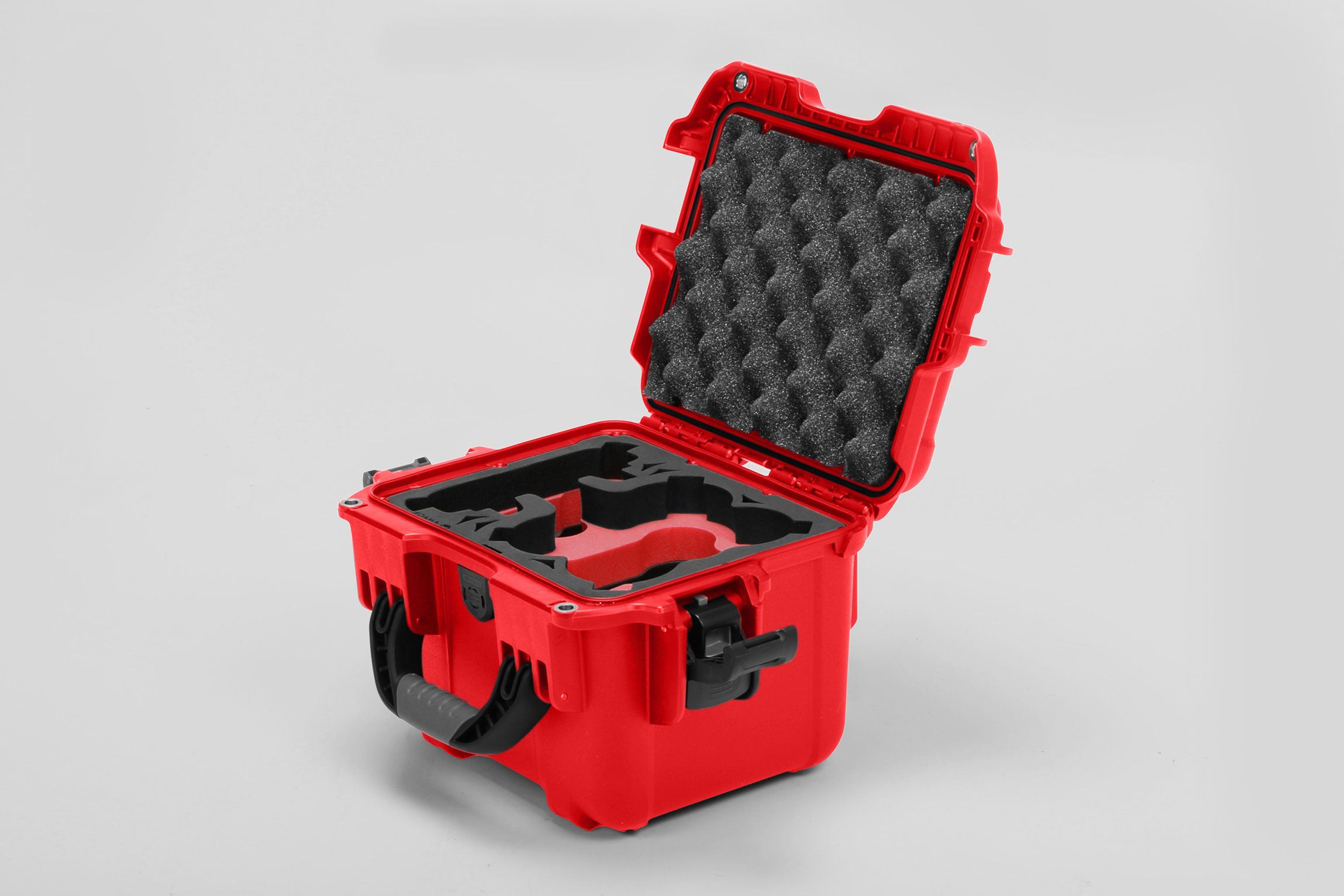 Angled view of DJI Neo Red Color Adventure Ready Compact Waterproof Carry-on Case and Custom Foam Insert with a Red Layer for DJI Neo