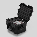 Angled view of DJI Neo Black Color Adventure Ready Compact Waterproof Carry-on Case and Custom Foam Insert with a Red Layer, holding the DJI Neo Combo