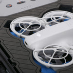 Close up view 1 of Foama black all-weather carry-on case with stylish blue layer insert, holding DJI Neo
